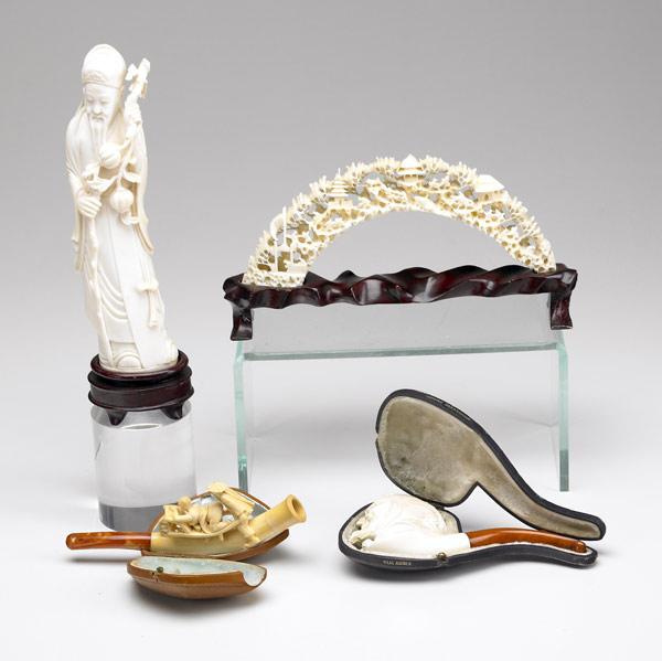 Appraisal: FOUR EUROPEAN OR ASIAN CARVINGS Erotic carved ivory and amber