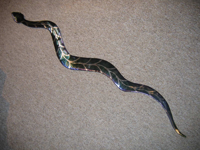 Appraisal: VOEPEL AMERICAN Steel snake with purple to green iridescent finish