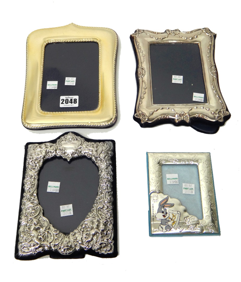 Appraisal: A silver mounted shaped rectangular photograph frame decorated with a