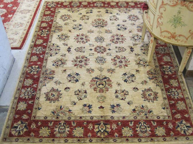 Appraisal: HAND KNOTTED ORIENTAL AREA RUG Pakistani-Persian the cream ground decorated