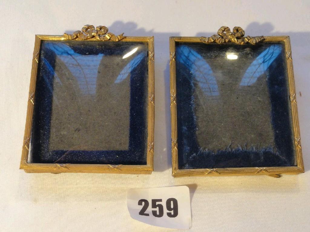 Appraisal: A pair of miniature picture frames with gilt and ribbon