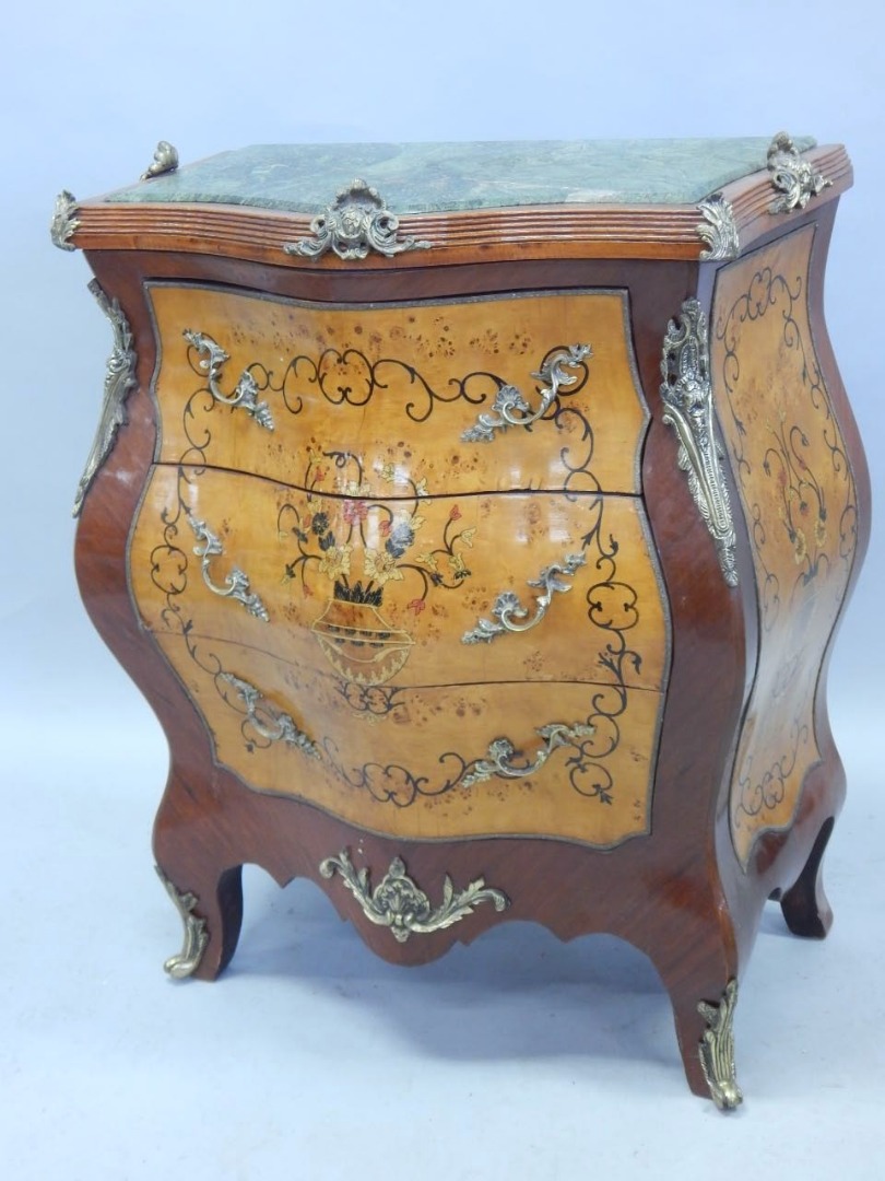 Appraisal: A Continental bombe shaped mahogany commode with gilt metal mounts