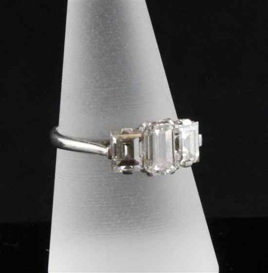 Appraisal: A platinum set three stone diamond ring with emerald cut