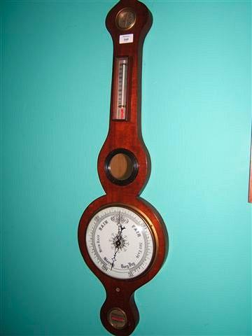 Appraisal: A mahogany barometer with onion top hydrometer thermometer and level