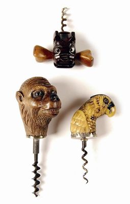 Appraisal: Three figural corkscrews a carved wood monkey head with glass