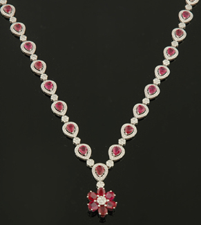 Appraisal: A ruby and diamond necklace Comprising thirty four pear cut