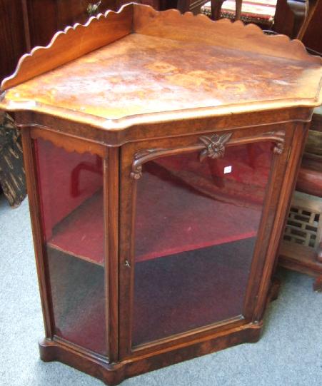 Appraisal: A th century walnut floor standing corner display cabinet with