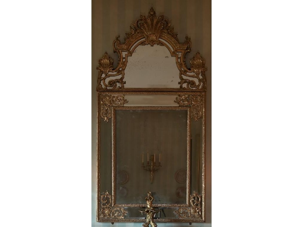 Appraisal: A REGENCE STYLE GILTWOOD MIRROR with an arched cresting inset