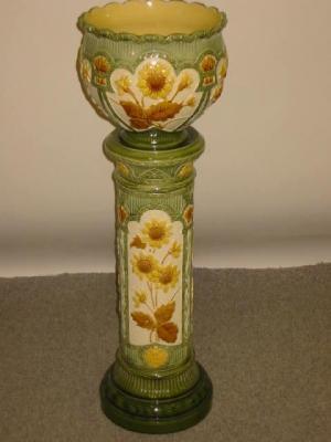 Appraisal: A BURMANTOFTS FAIENCE JARDINIERE AND STAND moulded in relief and