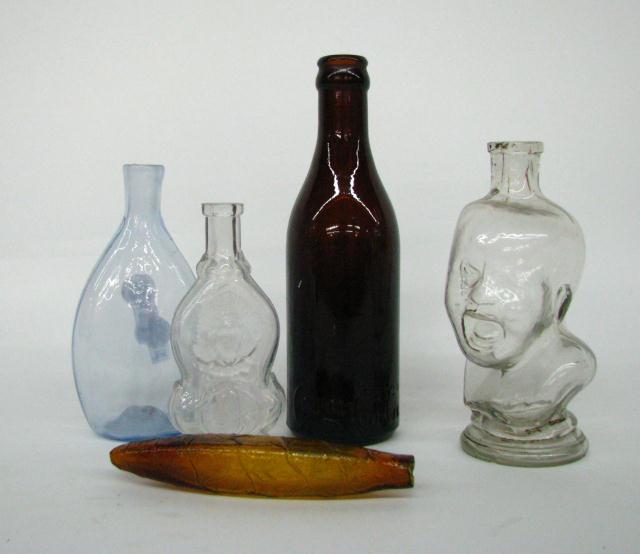 Appraisal: Group of five antique bottles including figural crying baby small