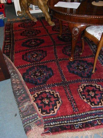 Appraisal: A KURDISH RUG woven with twelve medallions on a rose