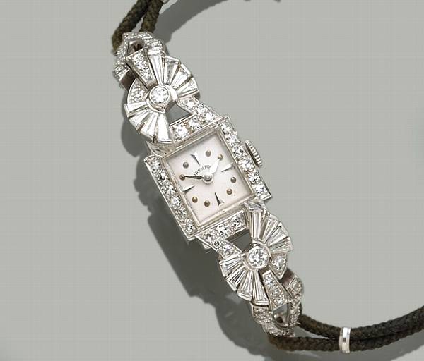 Appraisal: A lady's diamond and platinum wristwatch on a black cord