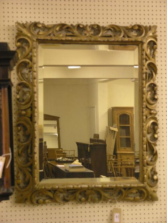 Appraisal: A rectangular wall mirror within carved gilt frame ft in