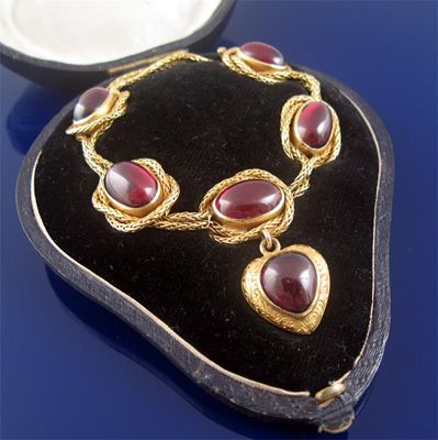 Appraisal: A Victorian gold bracelet mounted with five oval cabochon garnets