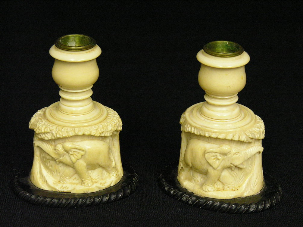 Appraisal: PAIR CARVED IVORY CANDLE-HOLDERS Elephant on one side and lion