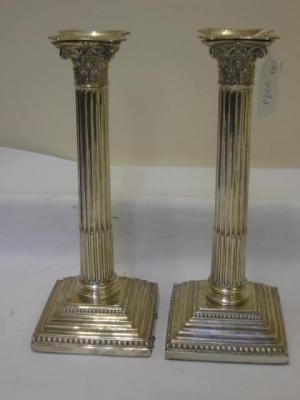 Appraisal: A PAIR OF VICTORIAN CANDLESTICKS modelled as Corinthian columns with