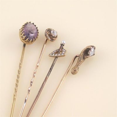 Appraisal: A diamond set gold swirl stick pin a diamond set