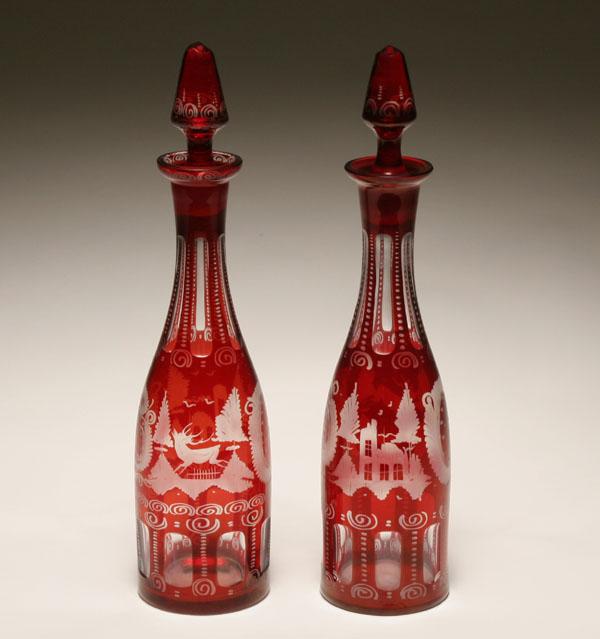 Appraisal: Bohemian ruby etched and cut glass decanters with leaping stag