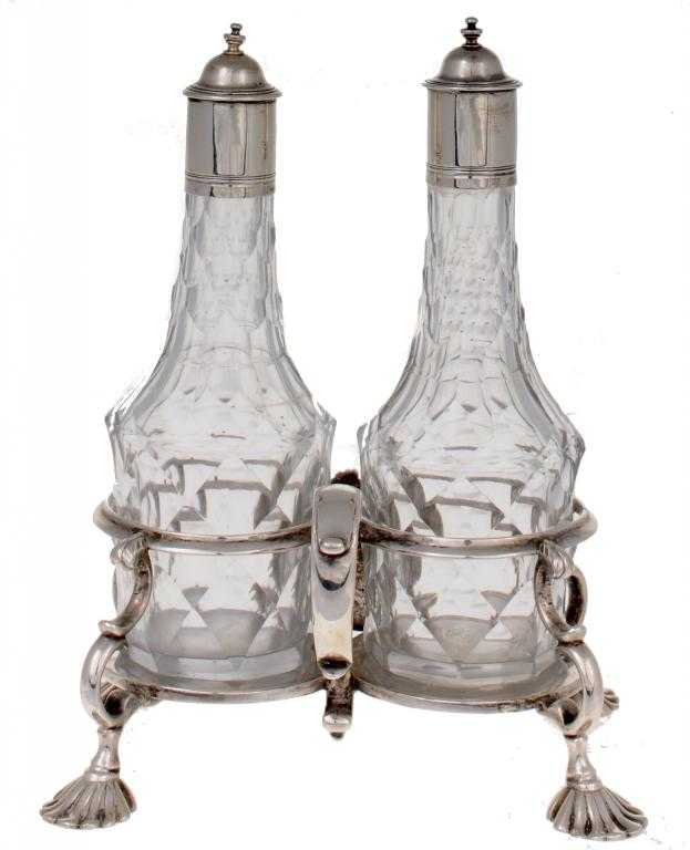 Appraisal: A GEORGE II OIL-AND-VINEGAR CRUET the frame applied with a