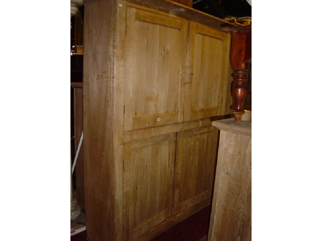 Appraisal: A large stripped pine side cupboard enclosed by two pairs