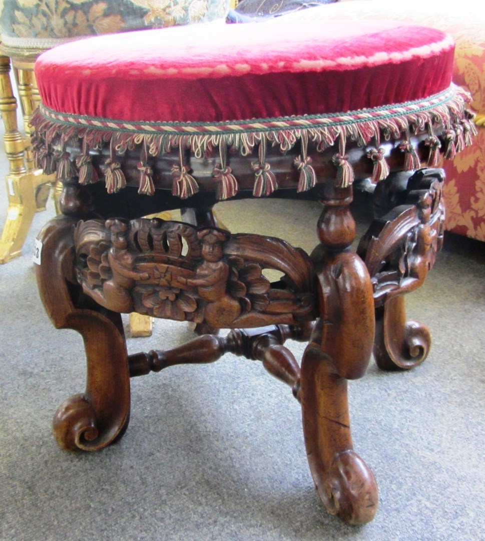 Appraisal: A th century design carved fruitwood circular stool with boys