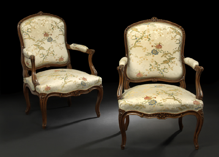 Appraisal: Pair of Provincial Louis XV-Style Fruitwood Fauteuils early th century