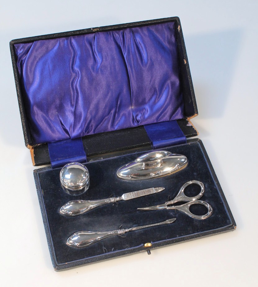 Appraisal: A George V silver travelling manicure set by Boots Pure