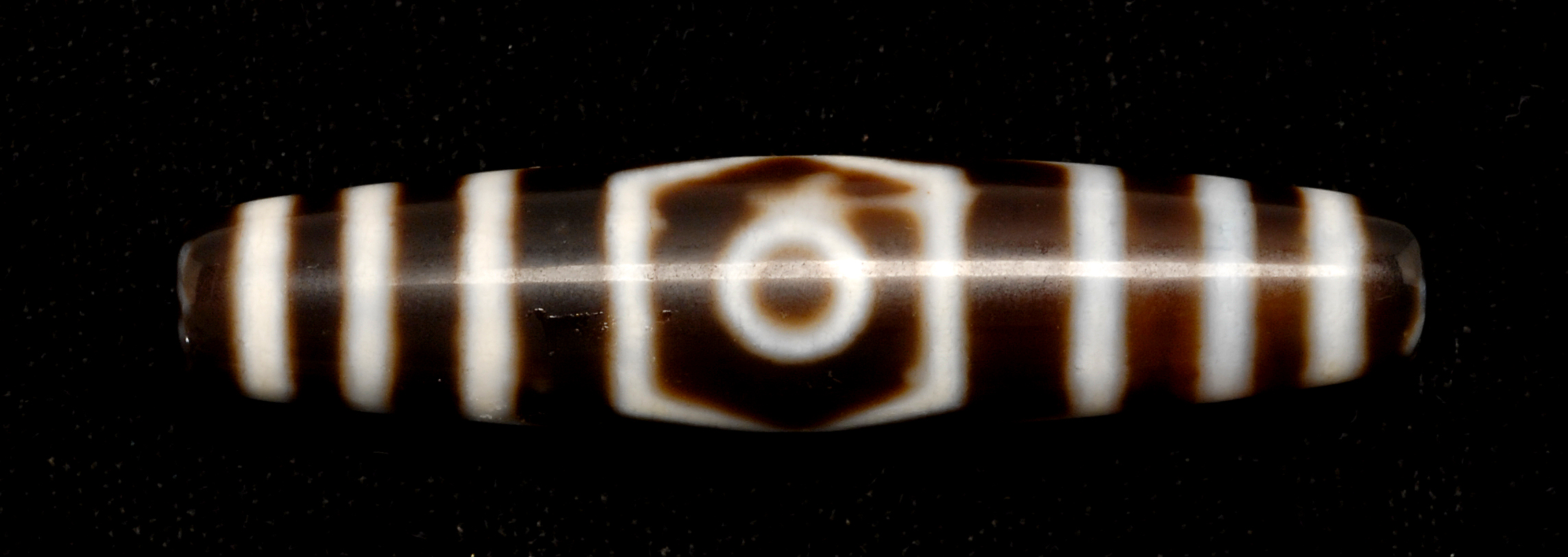 Appraisal: CHALCEDONY AGATE BEAD Tibet Circa In dramatic brown and white