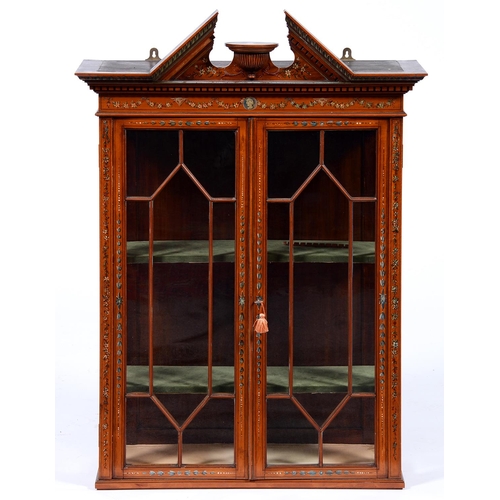 Appraisal: An Edwardian painted satinwood cabinet with open triangular cornice and