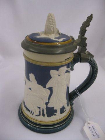 Appraisal: Mettlach Pottery Stein relief scene of people dining ear of