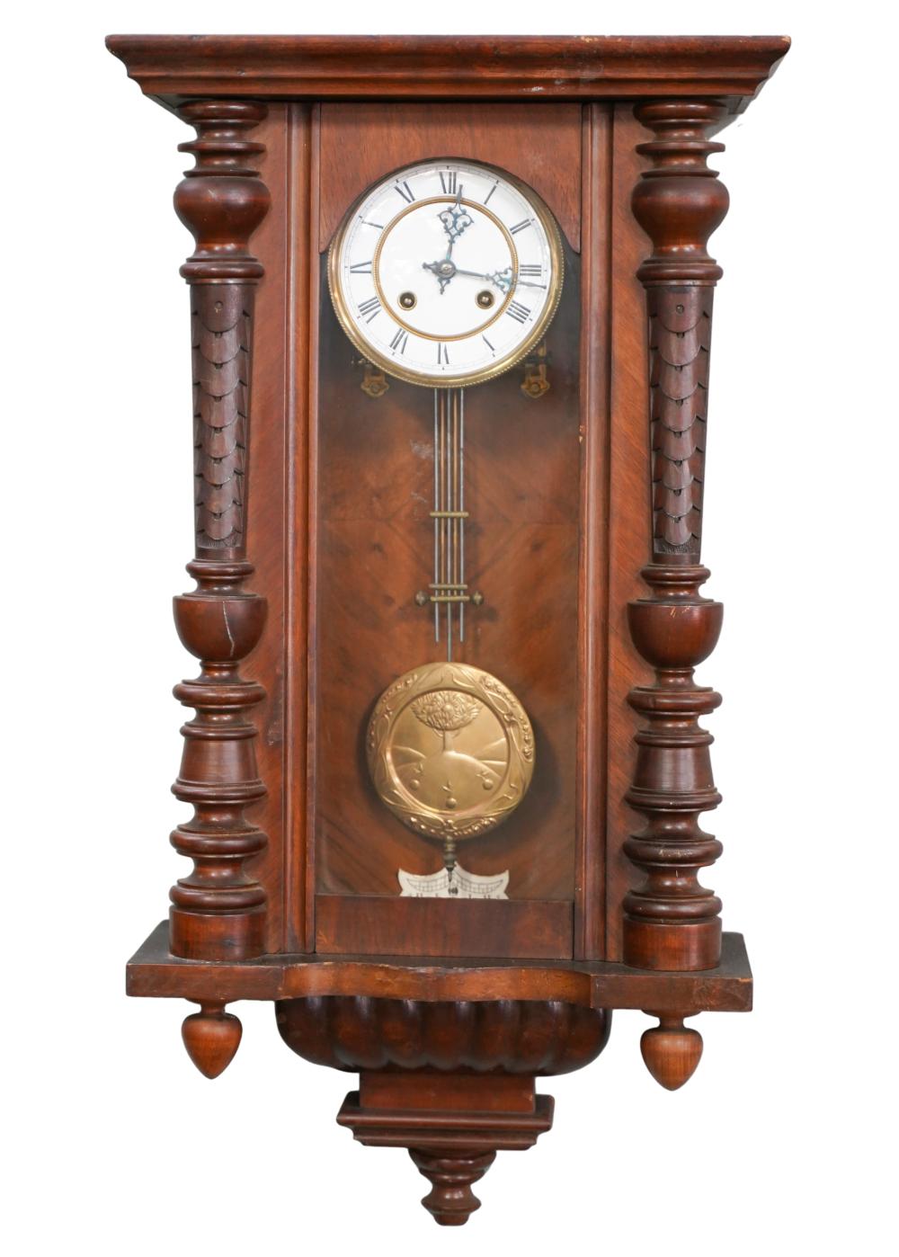 Appraisal: CARVED MAHOGANY WALL CLOCKunsigned with brass pendulum inches wide inches