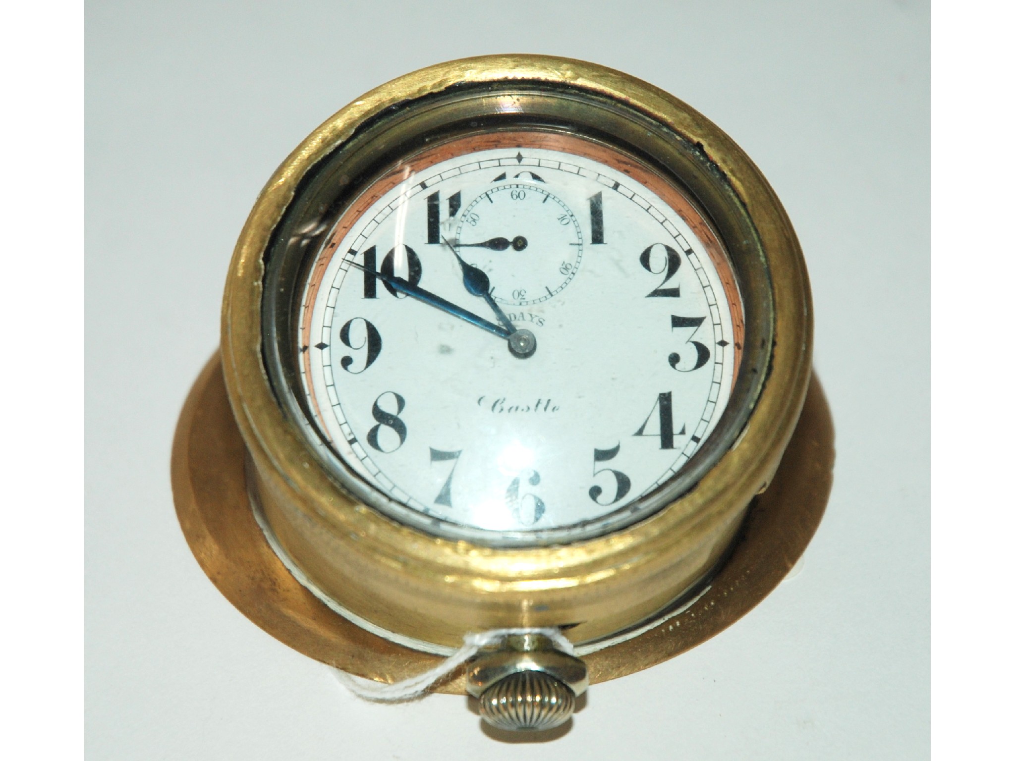 Appraisal: A white-metal and brass dash board clock by Castle