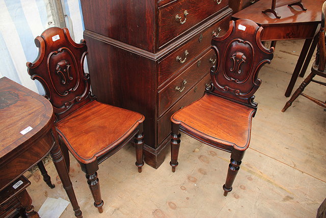 Appraisal: A PAIR OF VICTORIAN MAHOGANY SHIELD BACKED HALL CHAIRS with