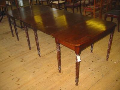 Appraisal: A REGENCY MAHOGANY EXTENDING DINING TABLE of rounded oblong form