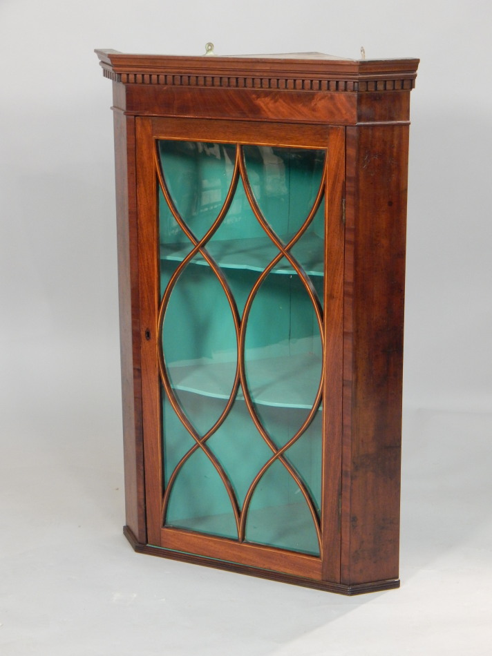 Appraisal: A George III mahogany corner cabinet the top with a