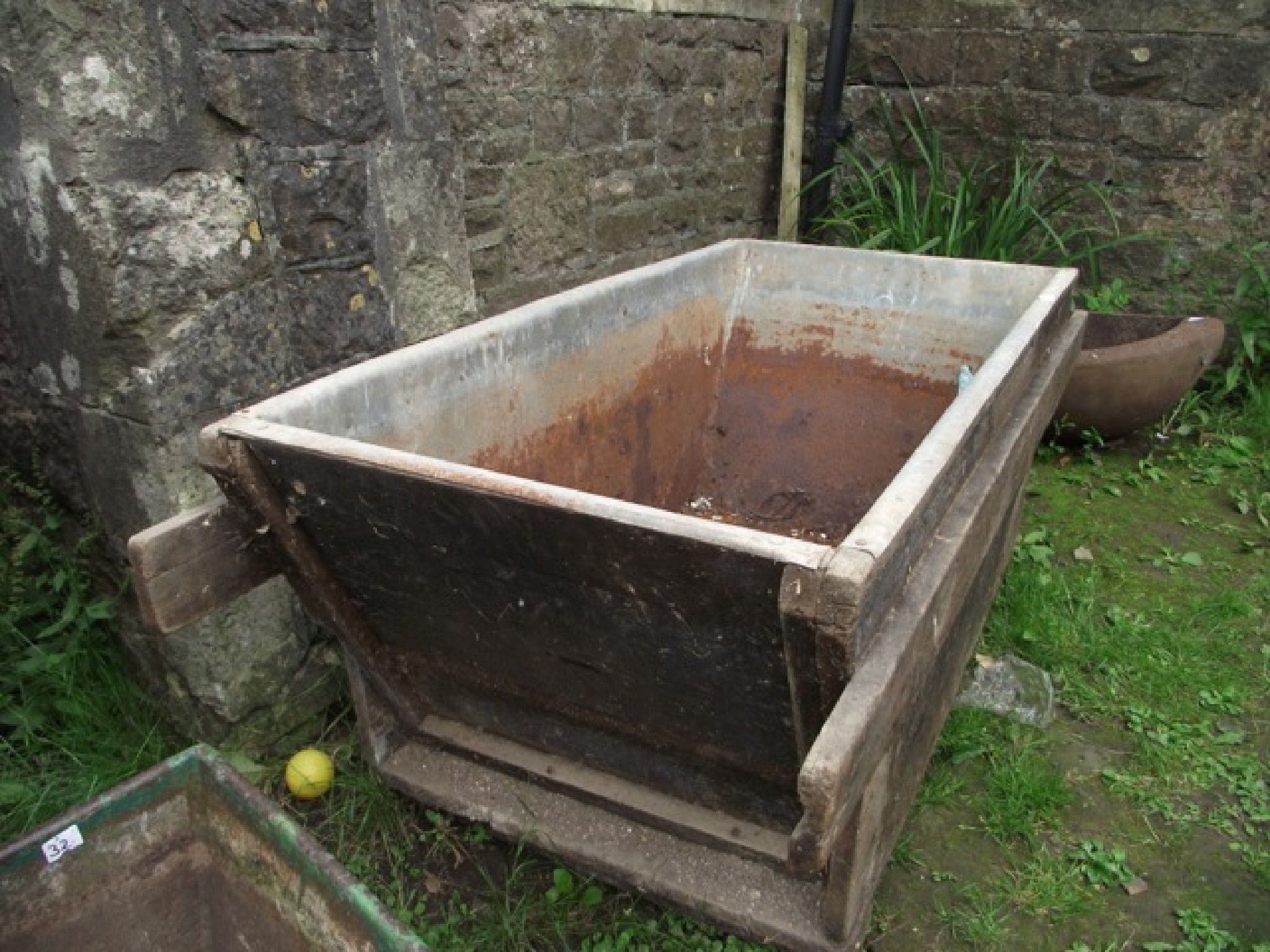 Appraisal: A vintage wooden framed and tin lined trough bin of