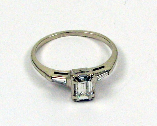 Appraisal: DIAMOND AND FOURTEEN KARAT GOLD RING centering a baguette-cut diamond