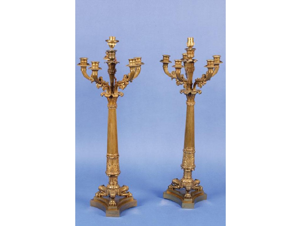 Appraisal: A PAIR OF EMPIRE GILT METAL CANDLESTICKS each with a