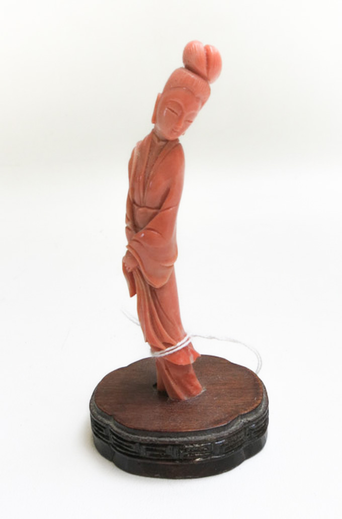 Appraisal: CHINESE CARVED CORAL QUAN YIN on shaped wood base height