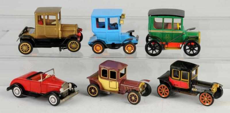 Appraisal: Lot of Tin Old-Timer Vehicle Toys Description Japanese One battery-operated