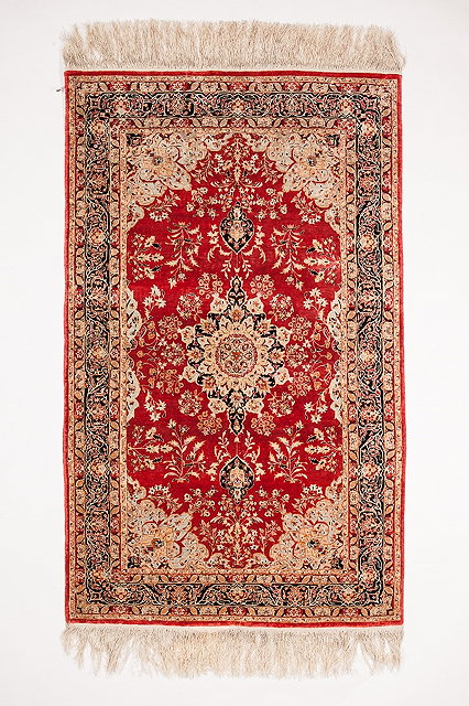 Appraisal: A CHINESE PERSIAN PATTERN SILK RUG with a central foliate