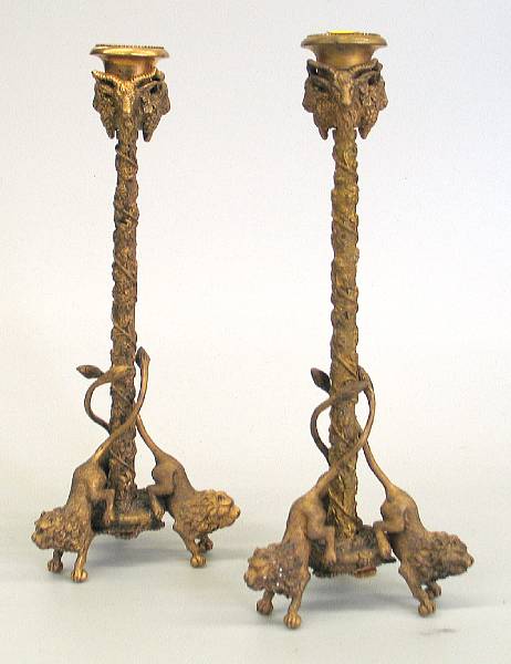 Appraisal: A pair of cast brass candlesticks modern Each vine cast