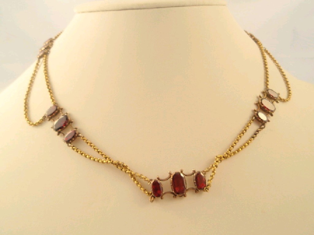 Appraisal: A thC necklace of almandine garnets set in three stone