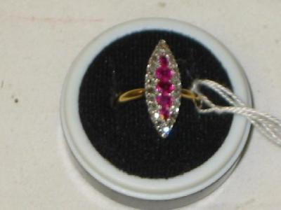 Appraisal: A MARQUISE RING with five rubies centrally set surrounded by