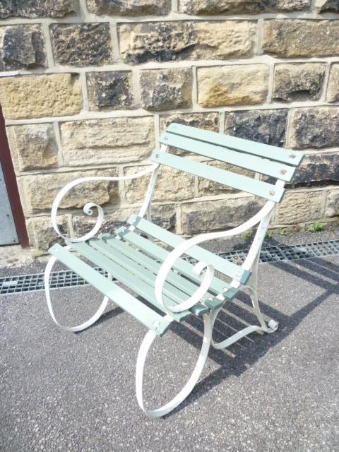 Appraisal: AN EDWARDIAN WROUGHT IRON GARDEN CHAIR with scrolling arms and