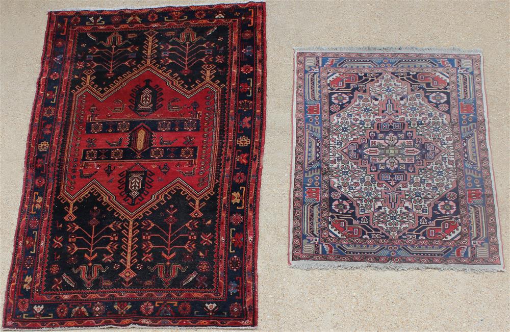 Appraisal: TWO GEOMETRIC DESIGN TRIBAL WOOL RUGS the smaller with central