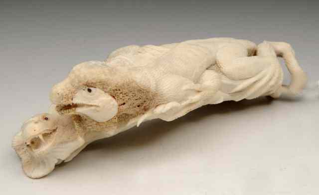 Appraisal: AN ASIAN CARVED CORAL MODEL of two interlocked komodo dragons