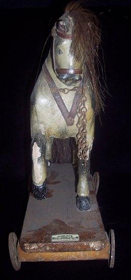 Appraisal: A child's painted plaster and wood pull-along horse the base