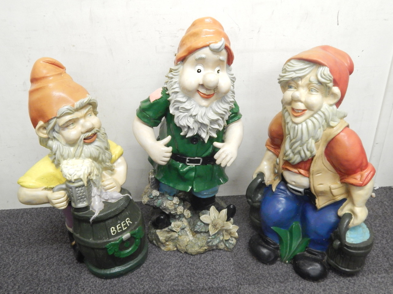 Appraisal: Three painted plastic large garden gnomes each in various poses