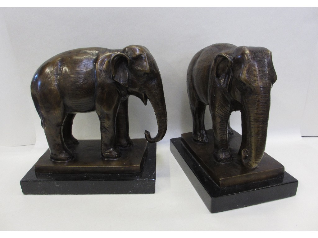 Appraisal: Pair of bronzed metal figures of elephants on black marble